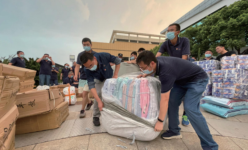 疫情期間，黨員干部沖在前面為員工搬運生活物資。王子維攝